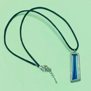 Blue stained glass pendant on black rope necklace